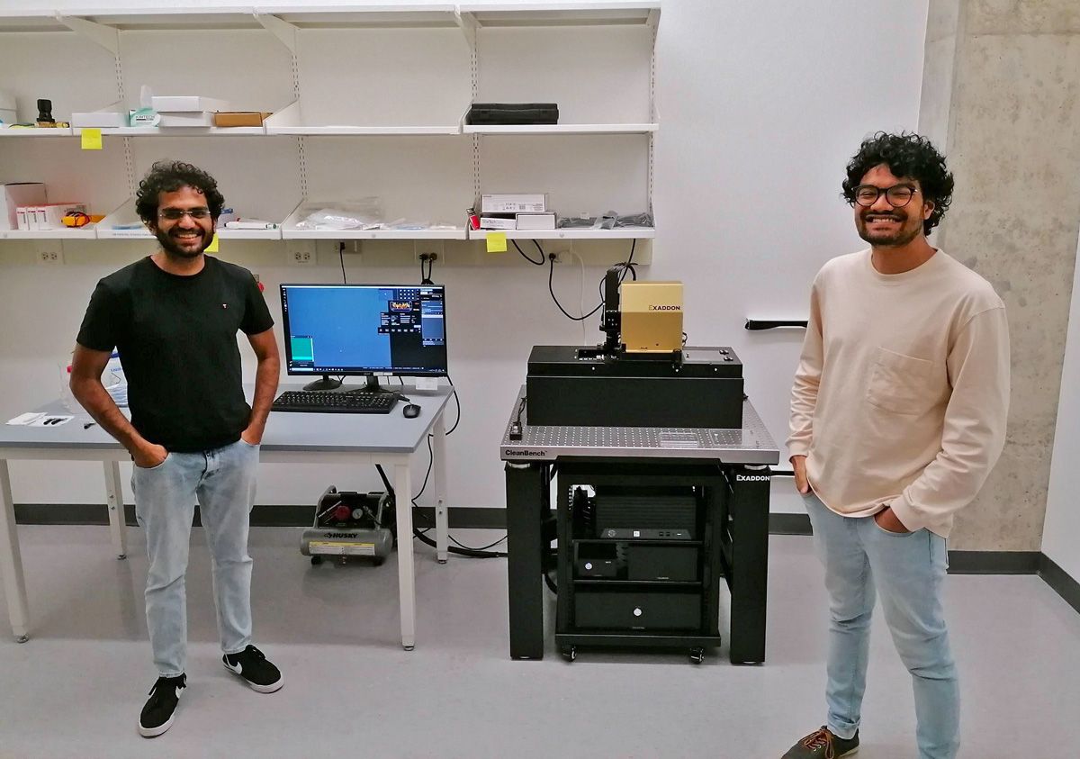 Purdue PhD students Om Kolhe and Hammad Khan in front of the CERES µAM print system, newly installed in the Nano Neurotechnology Lab