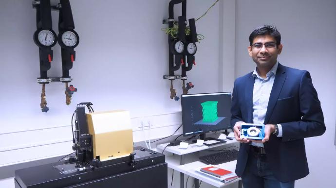 Dr. Ramachandramoorthy standing in front of the CERES μAM Print System at Max Planck Institute. Image source: MPIE